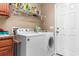 Laundry room with washer, dryer, and storage shelves at 818 Ingle Nook Ln., Longs, SC 29568