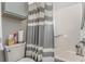 Small bathroom with shower and striped curtain at 101 S Barnwell St. # 38-A, North Myrtle Beach, SC 29582