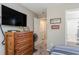 Bedroom with TV, dresser, and bathroom access at 101 S Barnwell St. # 38-A, North Myrtle Beach, SC 29582