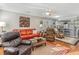 Open living space with orange couch and view into the kitchen at 101 S Barnwell St. # 38-A, North Myrtle Beach, SC 29582
