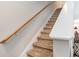 Carpeted staircase with wooden handrail at 101 S Barnwell St. # 38-A, North Myrtle Beach, SC 29582