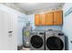 Convenient laundry room with washer, dryer, and cabinets at 1011 N Ocean Blvd. # 303-B, Surfside Beach, SC 29575