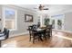 Bright dining room featuring a large table, hardwood floors, and access to a deck at 1050 Waccamaw Dr., Garden City Beach, SC 29576