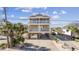 Two-story home with elevated foundation, balconies, and a spacious driveway at 1050 Waccamaw Dr., Garden City Beach, SC 29576
