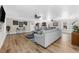 Spacious living room with hardwood floors, large sectional sofa, and ample natural light at 1050 Waccamaw Dr., Garden City Beach, SC 29576