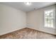 Bright bedroom with carpeted floor and large window at 1101 Ann St., North Myrtle Beach, SC 29582