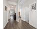 Long hallway with hardwood-style floors leading to bedrooms and other areas at 1143 Sennema Circle, Myrtle Beach, SC 29588