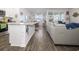 Open-concept kitchen with island, stainless steel appliances, and views into the living area at 1143 Sennema Circle, Myrtle Beach, SC 29588
