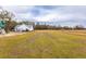 Large backyard with a view of the house and surrounding trees at 1200 Bergen Dr., Loris, SC 29569