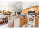 Bright kitchen with oak cabinets, stainless steel appliances, and tile floor at 1201 Cocksfoot Ln., Conway, SC 29527