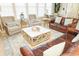 Living room with leather sofas, coffee table, and large windows at 142 Cypress Ave., Murrells Inlet, SC 29576