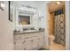 Bathroom with white vanity and patterned shower curtain at 2001 S Ocean Blvd. # 1102, Myrtle Beach, SC 29577