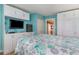 Bedroom with a beach-themed comforter, built-in shelving and closets at 2001 S Ocean Blvd. # 1102, Myrtle Beach, SC 29577