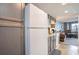 Kitchen area with white refrigerator and dark wood cabinets at 2001 S Ocean Blvd. # 1102, Myrtle Beach, SC 29577