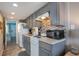Small kitchen with gray cabinets and granite countertops at 2001 S Ocean Blvd. # 1102, Myrtle Beach, SC 29577