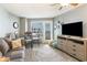 Living room with a sofa, dining table, and balcony access at 2001 S Ocean Blvd. # 1102, Myrtle Beach, SC 29577
