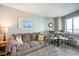 Bright living room with sofa, dining table, and ocean view artwork at 2001 S Ocean Blvd. # 1102, Myrtle Beach, SC 29577