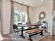 Modern farmhouse dining room with wood table and geometric patterned curtains at 2401 Grand Meadow Dr., Longs, SC 29568