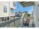 Relaxing deck with a chair and small table, overlooking neighboring houses at 300 47Th Ave. S # 2C, North Myrtle Beach, SC 29582