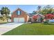 Brick house with two-car garage and landscaped lawn at 305 Duel Ct., Myrtle Beach, SC 29588