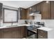 Modern kitchen with stainless steel appliances and dark wood cabinets at 305 S 21St Ave. S # 112, Myrtle Beach, SC 29577