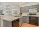 Kitchen with gray cabinets, white countertops, and black appliances at 473 White River Dr. # 33F, Myrtle Beach, SC 29579