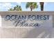 Ocean Forest Plaza building entrance sign with palm trees in the background at 5523 N Ocean Blvd. # 1812, Myrtle Beach, SC 29577