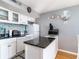 Condo kitchen with white cabinets, granite countertops, and tile backsplash at 5523 N Ocean Blvd. # 1812, Myrtle Beach, SC 29577