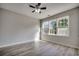 Well-lit bedroom with large window and hardwood floors at 5801 Oyster Catcher Dr. # 1022, North Myrtle Beach, SC 29582
