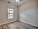 Spacious bedroom with wood-look floors and a window at 5801 Oyster Catcher Dr. # 1022, North Myrtle Beach, SC 29582