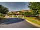 Green two-story clubhouse with wrap-around porch and landscaped grounds at 5801 Oyster Catcher Dr. # 1022, North Myrtle Beach, SC 29582