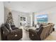 Living room with brown reclining sofas, a Christmas tree and large TV at 62 S Reindeer Rd., Surfside Beach, SC 29575