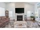 Bright living room featuring a cozy fireplace and large TV at 714 Little Fawn Way, Myrtle Beach, SC 29579