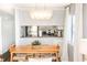 Dining area with a long wooden table and modern chandelier at 824 N Waccamaw Dr. # 206, Garden City Beach, SC 29576