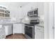 Corner kitchen with white cabinets, granite countertops, and stainless steel appliances at 926 Sandridge Rd., Little River, SC 29566