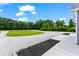 Landscaped side yard with gravel driveway at 926 Sandridge Rd., Little River, SC 29566