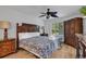 Spacious bedroom with king-size bed, wood furniture, and ceiling fan at 101 Westhill Circle # 5-C, Myrtle Beach, SC 29572
