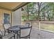 Deck with round metal table and chairs, overlooking trees and other condos at 101 Westhill Circle # 5-C, Myrtle Beach, SC 29572