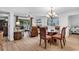 Dining area with a round glass table and wooden chairs, adjacent to living room at 101 Westhill Circle # 5-C, Myrtle Beach, SC 29572