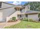 Gray siding condo with stairs leading to entrance, landscaping, and a grassy area at 101 Westhill Circle # 5-C, Myrtle Beach, SC 29572