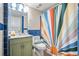 Bathroom with green vanity and colorful shower curtain at 1605 S Ocean Blvd. # 1807, Myrtle Beach, SC 29577