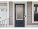 Dark gray front door with a frosted glass panel at 2327 Lark Sparrow St., Myrtle Beach, SC 29577
