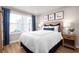 Bright bedroom with large window, hardwood floors, and stylish bedding at 2709 Rowyn St., Longs, SC 29568