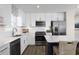 Modern kitchen with white cabinets, quartz countertops, and stainless steel appliances at 2709 Rowyn St., Longs, SC 29568