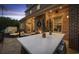 Outdoor patio with seating and bar area at night at 158 Knotty Pine Way, Murrells Inlet, SC 29576