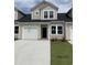 Two-story tan home with white garage door and landscaping at 178 Hoffman Park Dr. # 22, Myrtle Beach, SC 29588