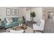 Living room with teal couch and white armchair at 189 Ashworth Dr., Tabor City, NC 28463