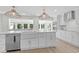 Modern kitchen with white cabinets, farmhouse sink, and stainless steel appliances at 204 Green Lake Dr., Myrtle Beach, SC 29572