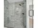 Walk-in shower with gray tile and glass enclosure at 204 Green Lake Dr., Myrtle Beach, SC 29572