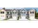 Image shows four townhouses with gray and beige siding, white garage doors, and landscaping at 261 Christiana Ln. # B, Myrtle Beach, SC 29579